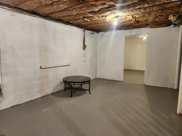 a view of a room with table and chairs