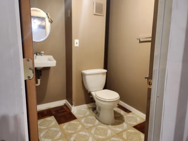 a bathroom with a toilet and a mirror