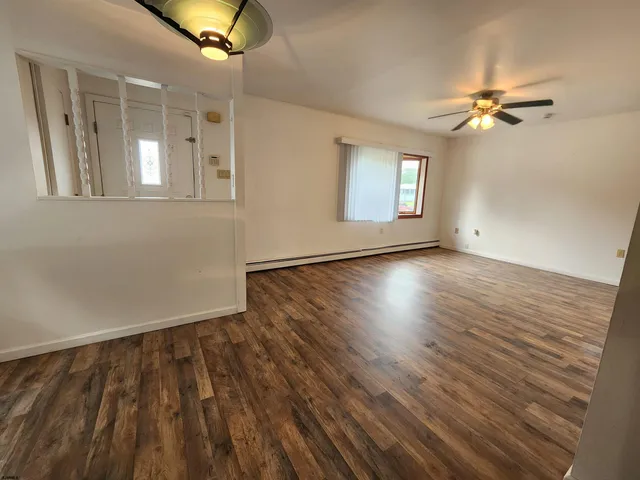 wooden floor in an empty room with a window