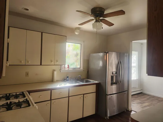 a kitchen with stainless steel appliances granite countertop a refrigerator a sink and a stove