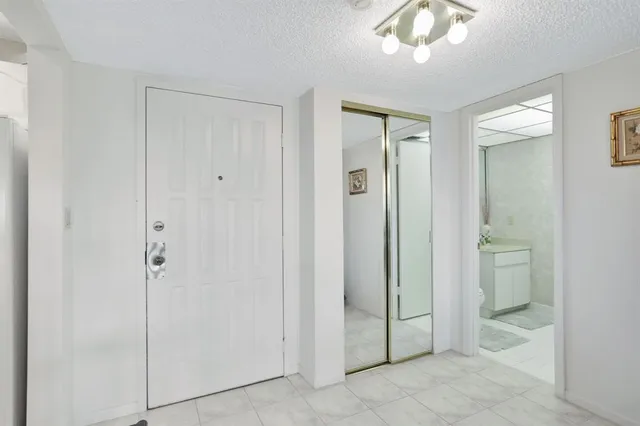 a bathroom with a granite countertop toilet a sink and a mirror