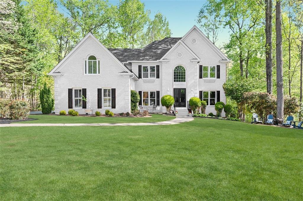 a front view of a house with a garden and porch