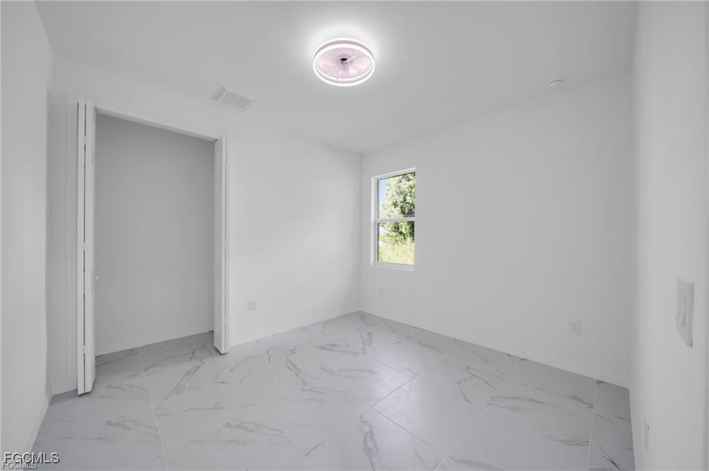 4308 15th Street Southwest Lehigh Acres, FL 33976 - Photo 11 of 27 an empty room with a window