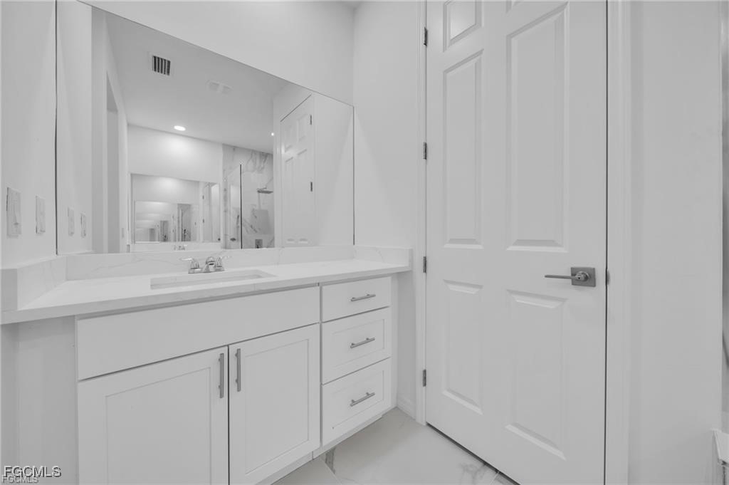 4308 15th Street Southwest Lehigh Acres, FL 33976 - Photo 17 of 27 a bathroom with a double vanity sink and mirror