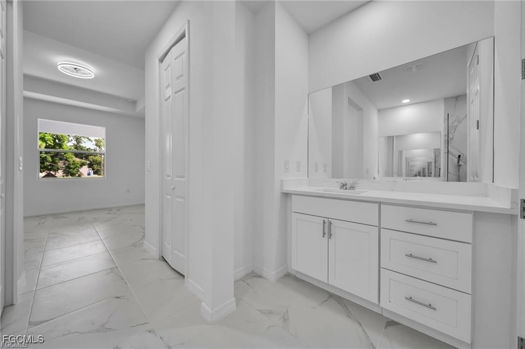 4308 15th Street Southwest Lehigh Acres, FL 33976 - Photo 20 of 27 a bathroom with a sink and a mirror