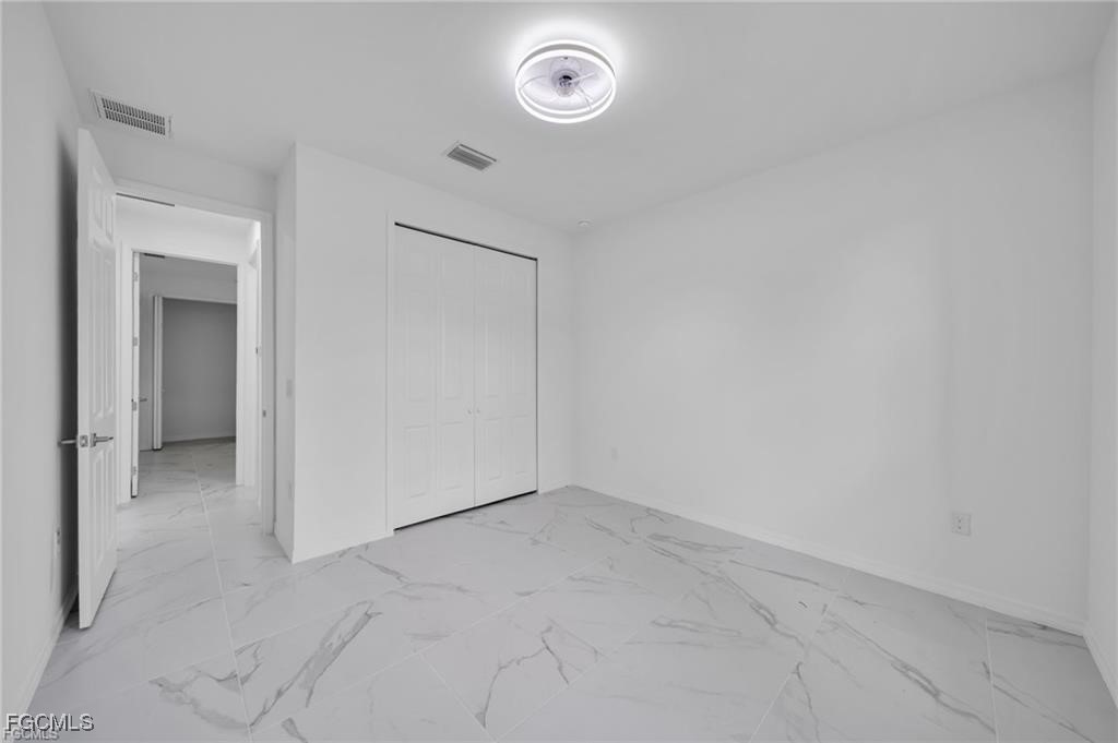 4308 15th Street Southwest Lehigh Acres, FL 33976 - Photo 21 of 27 an empty room with a washer and dryer