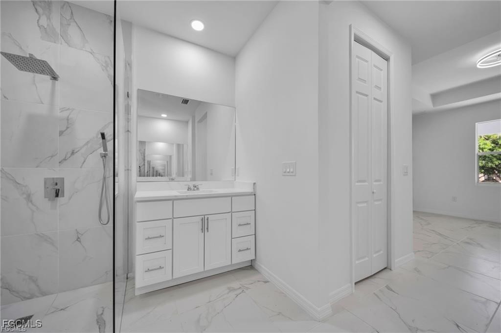 4308 15th Street Southwest Lehigh Acres, FL 33976 - Photo 22 of 27 a bathroom with a shower and a sink
