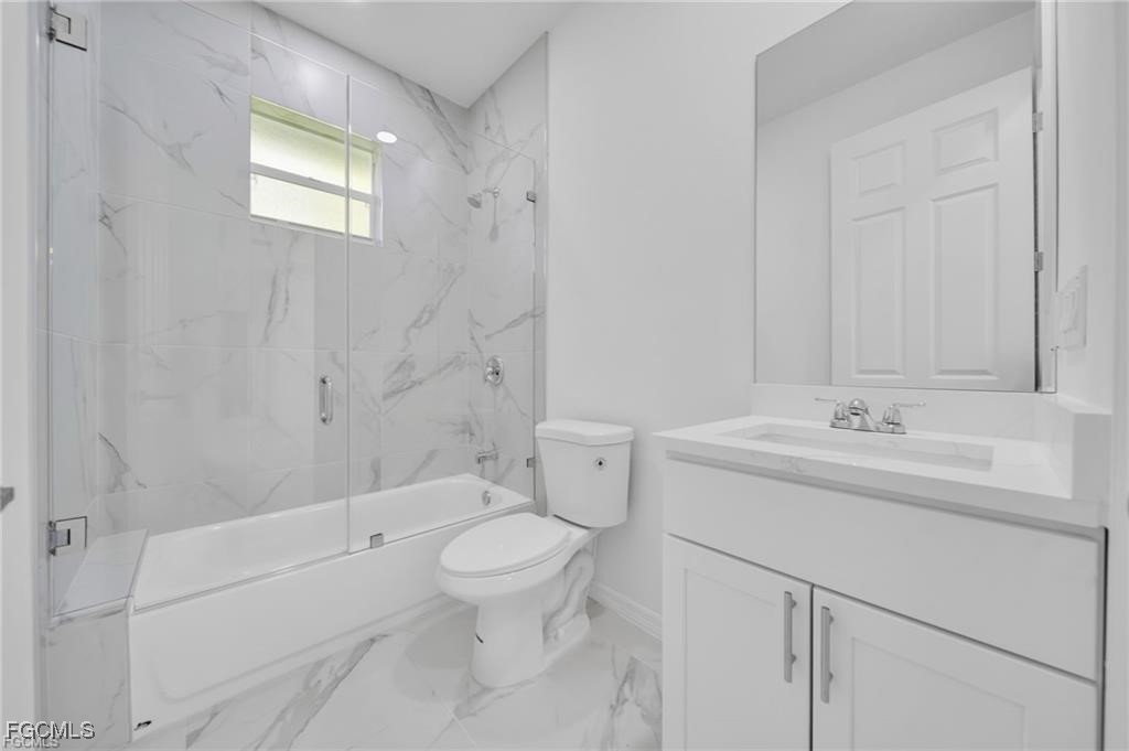 4308 15th Street Southwest Lehigh Acres, FL 33976 - Photo 9 of 27 a bathroom with a sink a toilet and shower