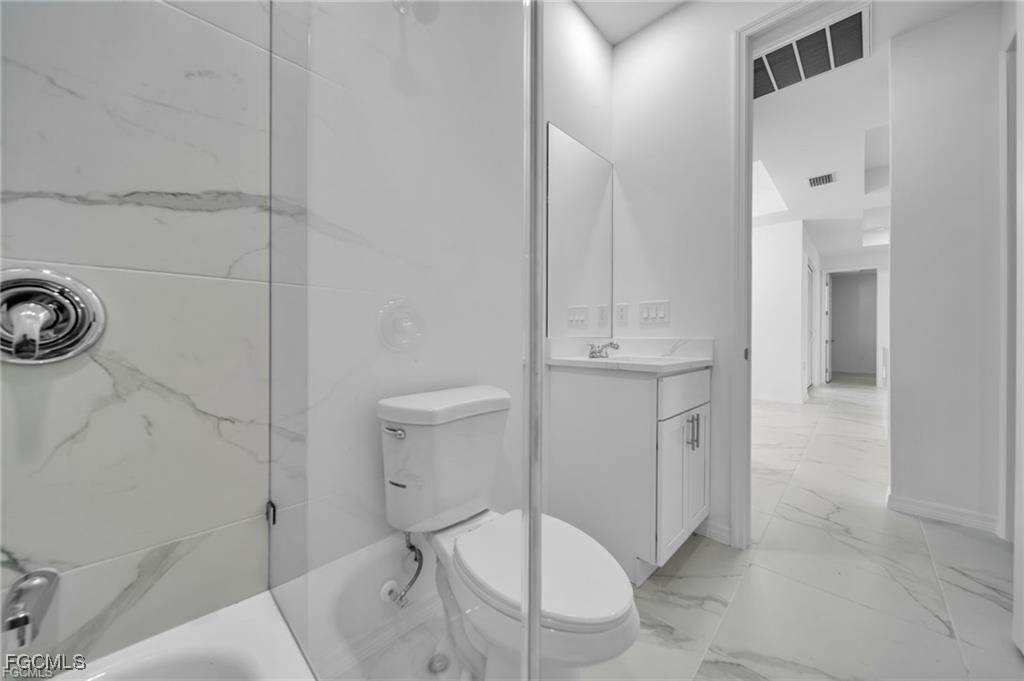 4308 15th Street Southwest Lehigh Acres, FL 33976 - Photo 10 of 27 a bathroom with a sink toilet and shower