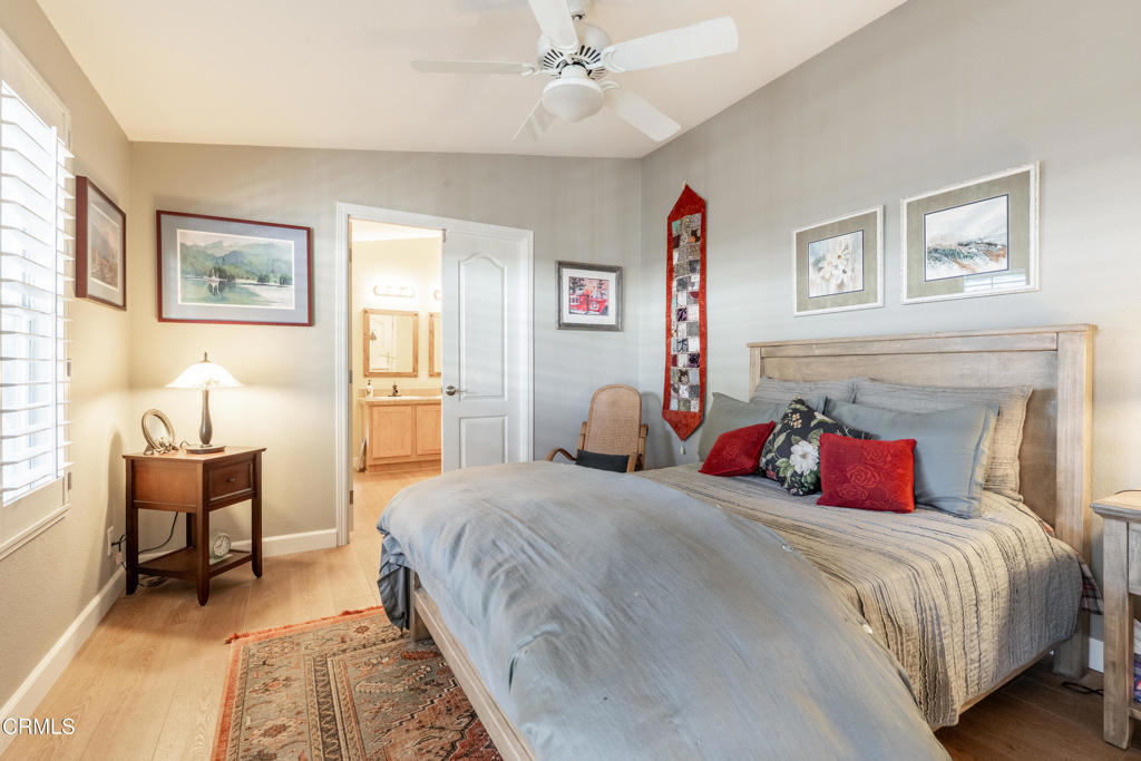 1273 South Rice Road, Unit 12 Ojai, CA 93023 - Photo 13 of 27 a bedroom with a large bed and a chandelier