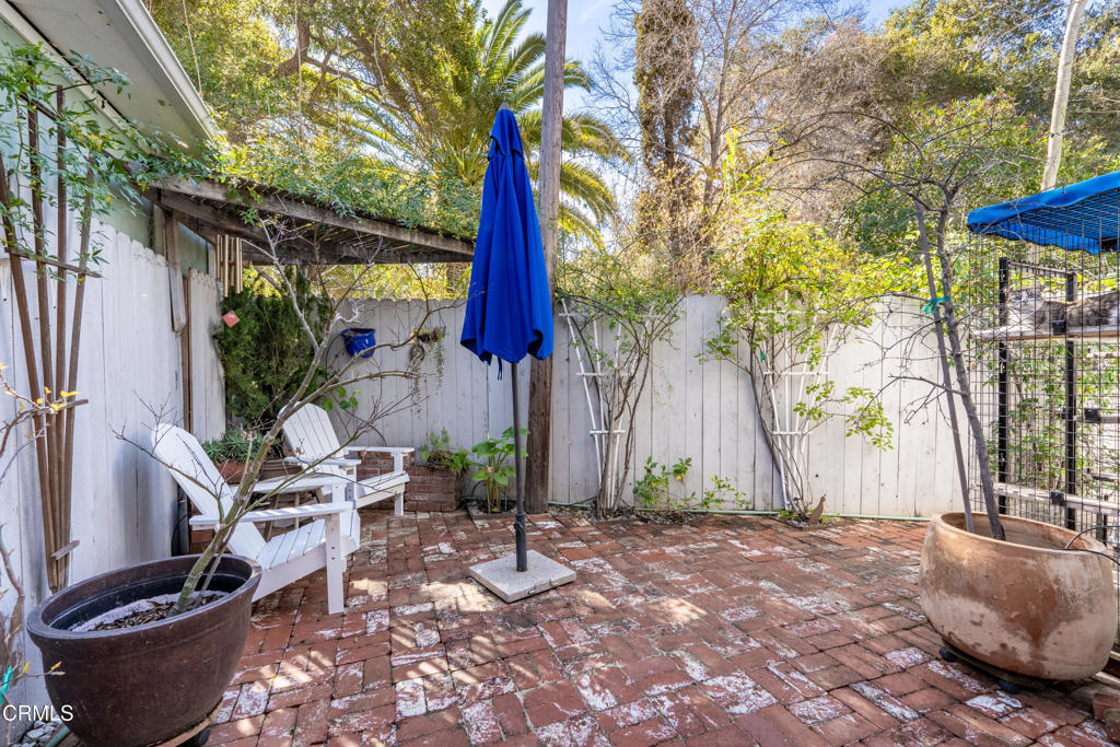 1273 South Rice Road, Unit 12 Ojai, CA 93023 - Photo 21 of 27 a view of a backyard with potted plants and a large tree