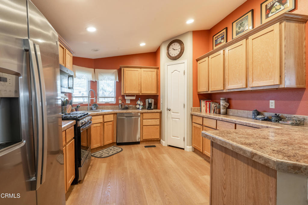 1273 South Rice Road, Unit 12 Ojai, CA 93023 - Photo 9 of 27 a kitchen with a refrigerator a sink and cabinets