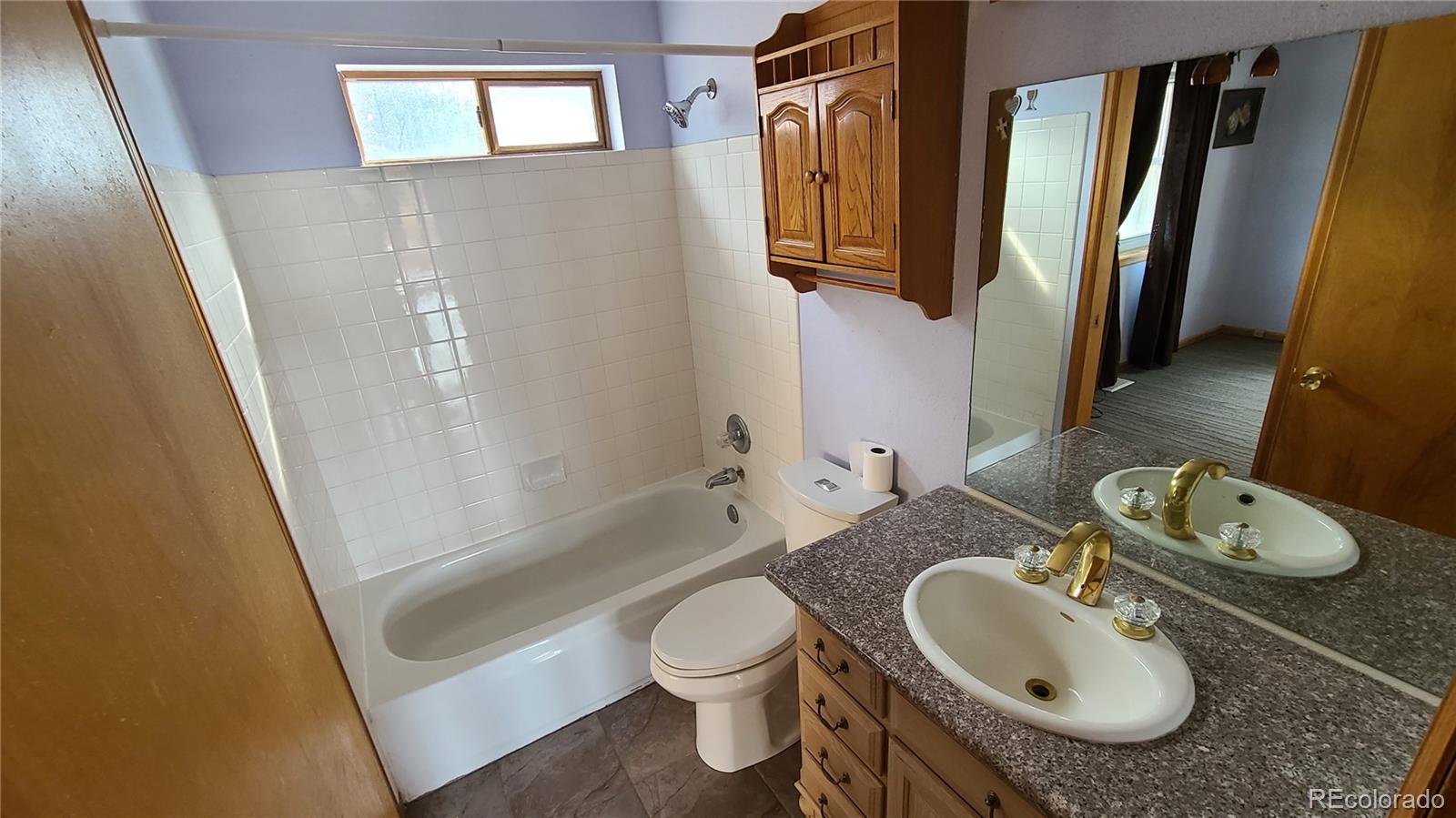 445 Rosalie Road Bailey, CO 80421 - Photo 13 of 21 a bathroom with a granite countertop sink toilet and shower a mirror