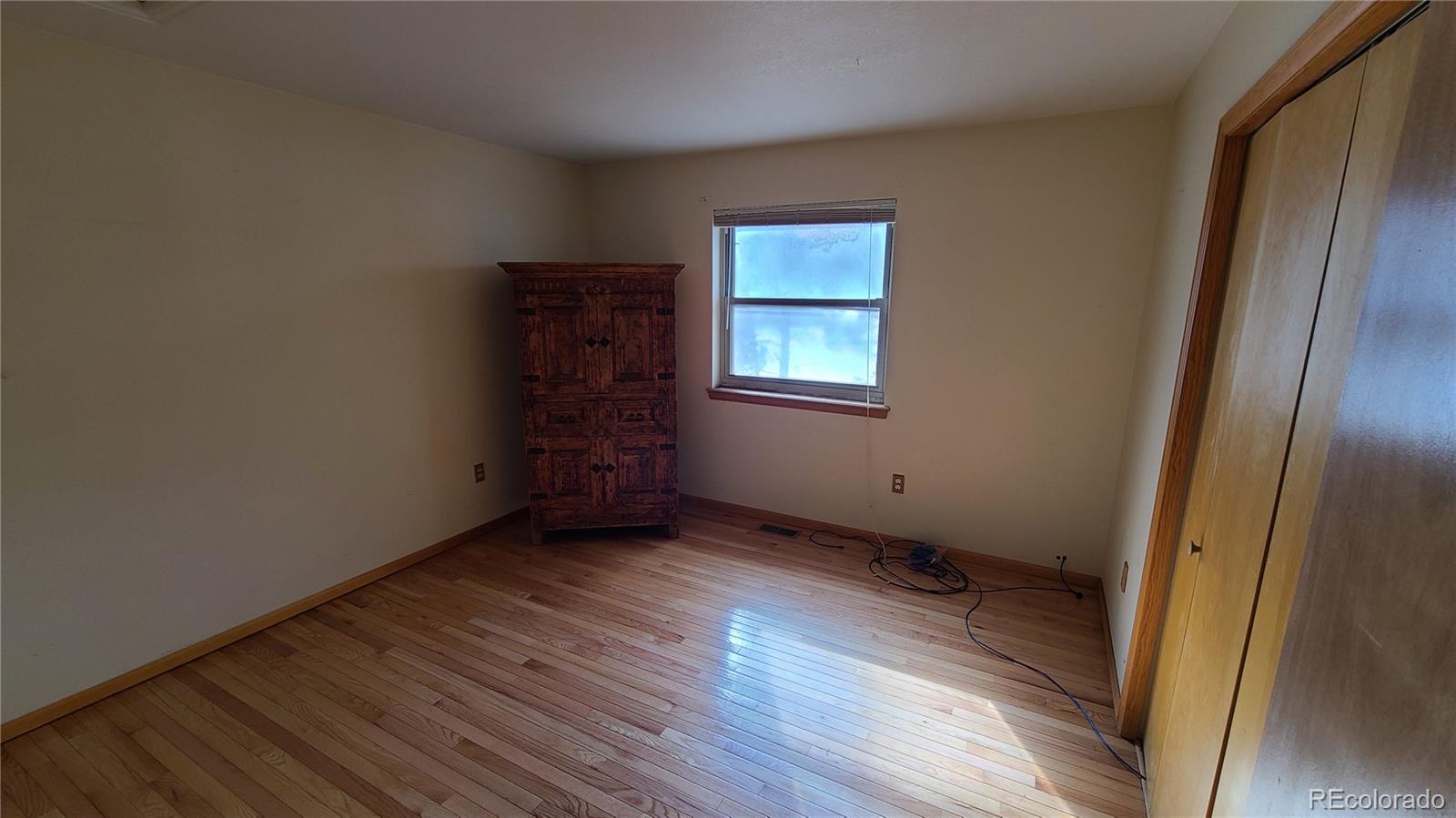 445 Rosalie Road Bailey, CO 80421 - Photo 14 of 21 a view of an empty room with wooden floor and a window