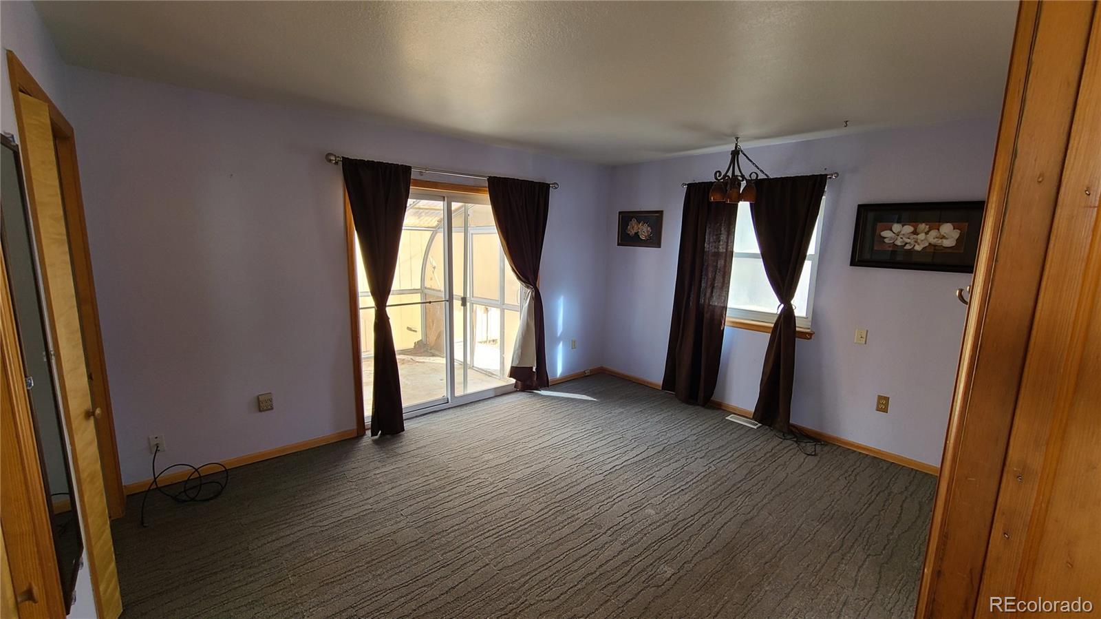 445 Rosalie Road Bailey, CO 80421 - Photo 15 of 21 an empty room with wooden floor and a window