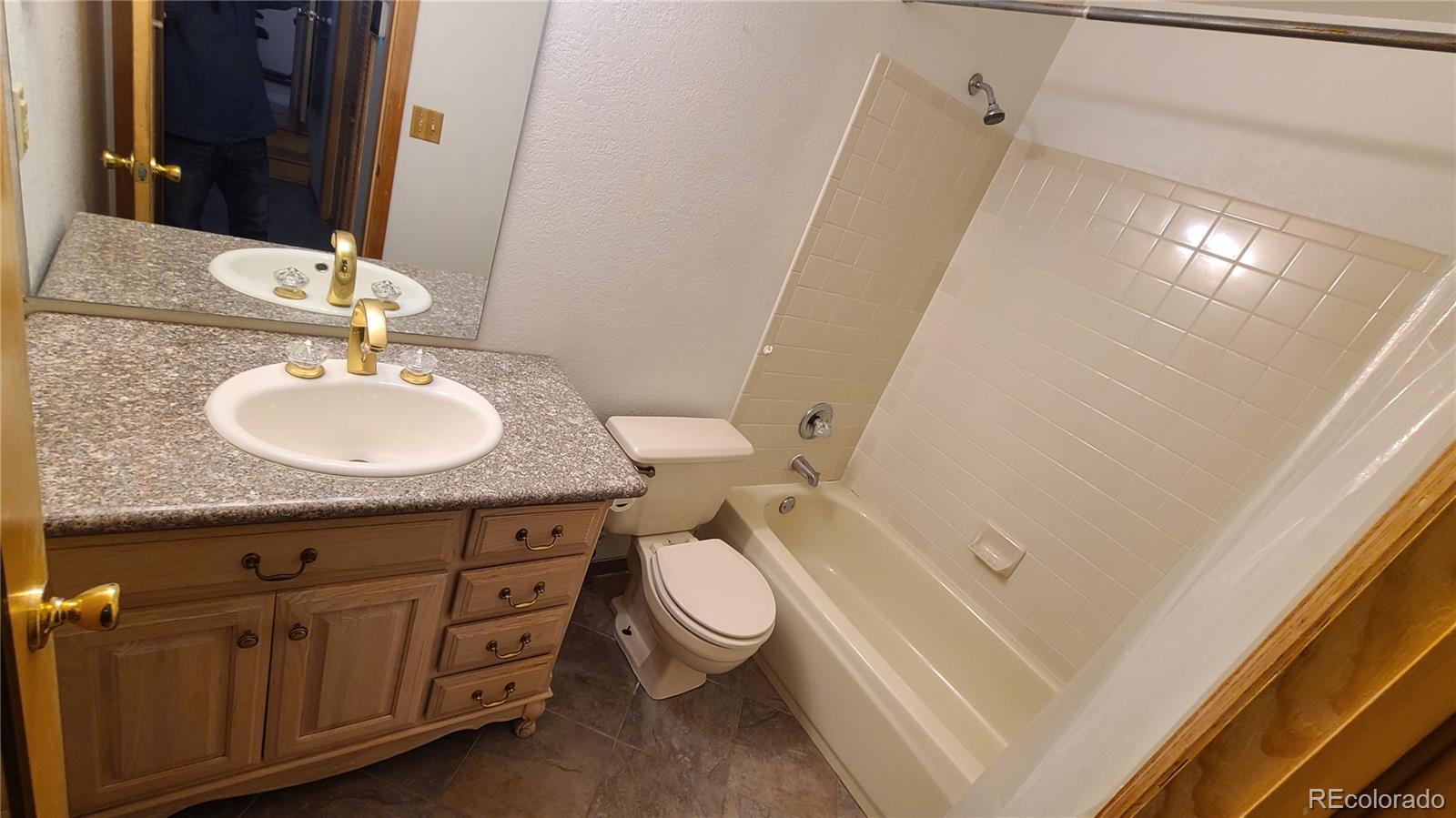 445 Rosalie Road Bailey, CO 80421 - Photo 21 of 21 a bathroom with a granite countertop sink toilet and a mirror