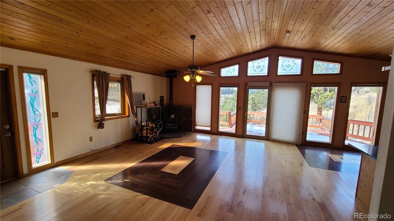 445 Rosalie Road Bailey, CO 80421 - Photo 4 of 21 a big room with wooden floor and windows