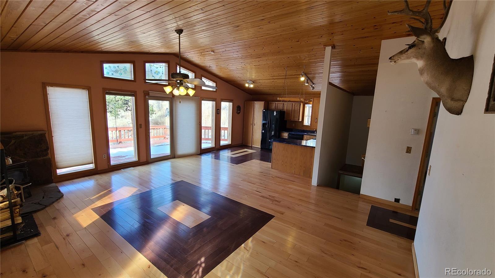 445 Rosalie Road Bailey, CO 80421 - Photo 5 of 21 a view of a hallway with wooden floor and furniture