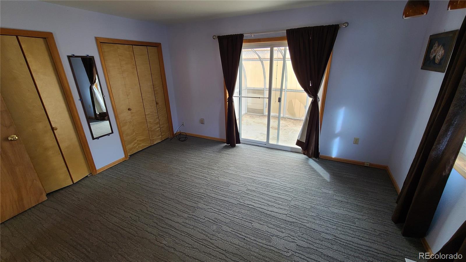 445 Rosalie Road Bailey, CO 80421 - Photo 8 of 21 an empty room with wooden floor and a window