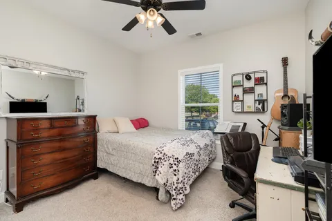 a bedroom with a bed and a chandelier