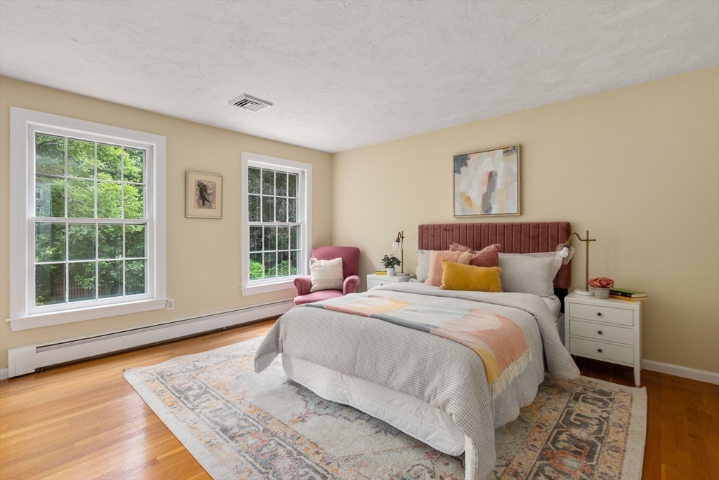 120 Lincoln Road Wayland, MA 01778 - Photo 24 of 34 a spacious bedroom with a bed and wooden floor