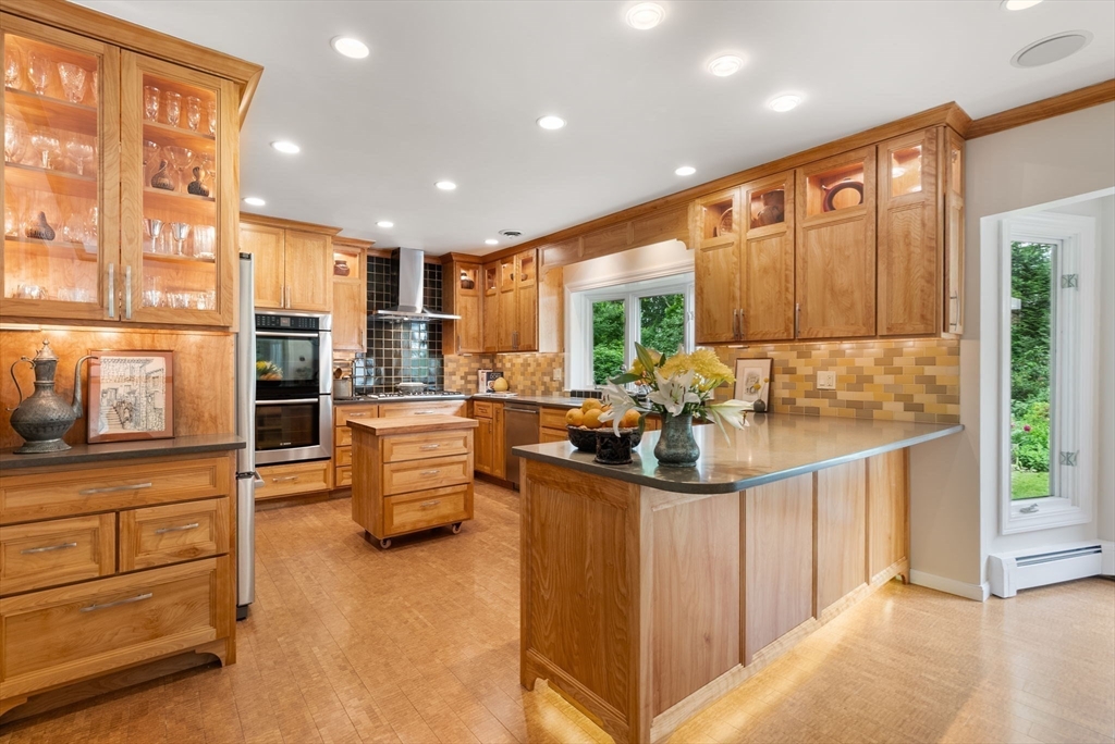 120 Lincoln Road Wayland, MA 01778 - Photo 10 of 34 a kitchen with stainless steel appliances kitchen island granite countertop a sink and cabinets