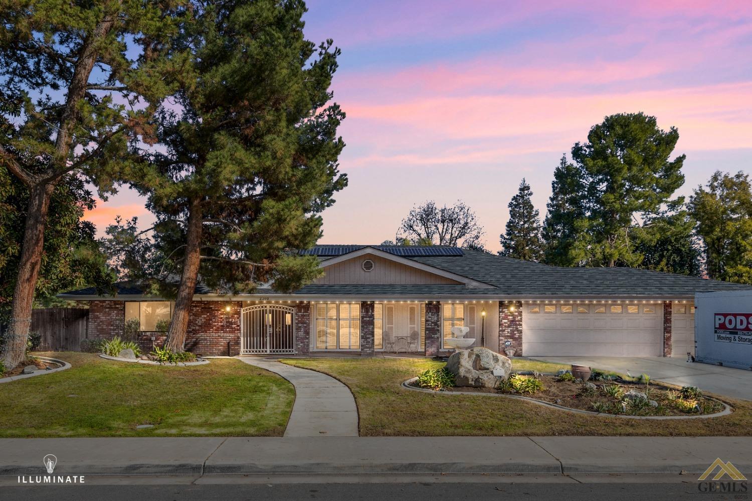 a front view of a house with a garden