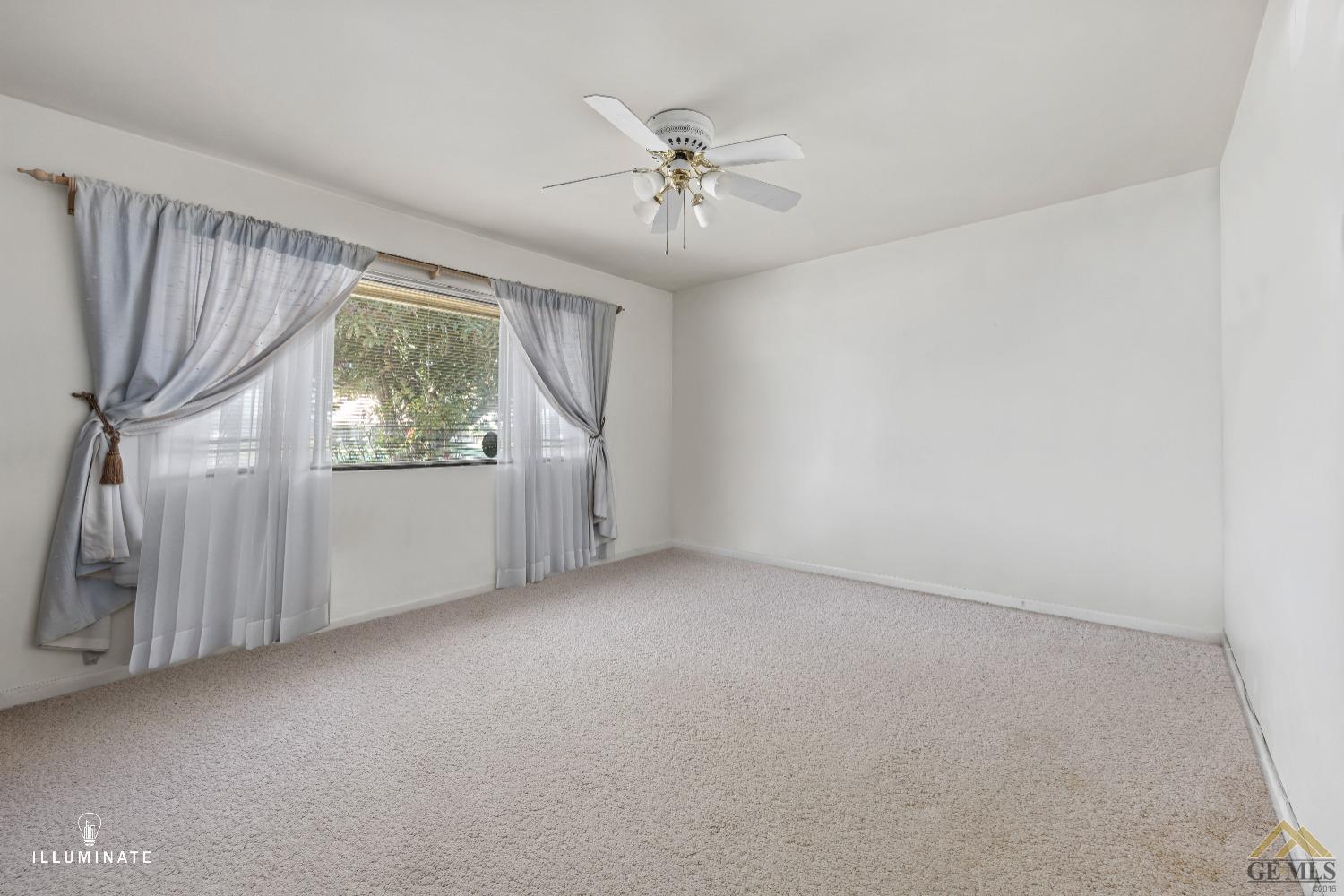 Undisclosed Address Bakersfield, CA 93311 - Photo 11 of 14 an empty room with a ceiling fan and window