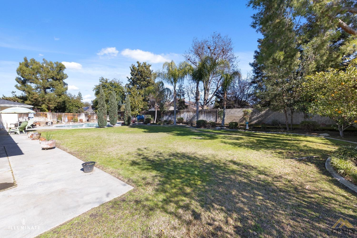 Undisclosed Address Bakersfield, CA 93311 - Photo 12 of 14 a view of a swimming pool with a yard