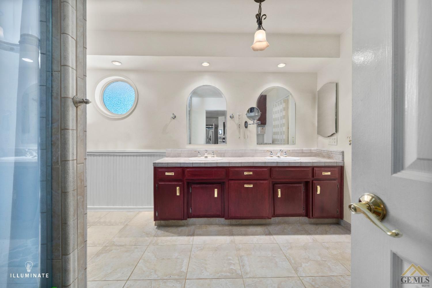 Undisclosed Address Bakersfield, CA 93311 - Photo 10 of 14 a bathroom with a granite countertop double vanity sink and a mirror