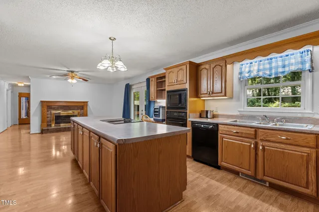 a kitchen with stainless steel appliances granite countertop a stove and a sink
