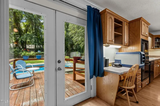 a dining room with furniture and a floor to ceiling window