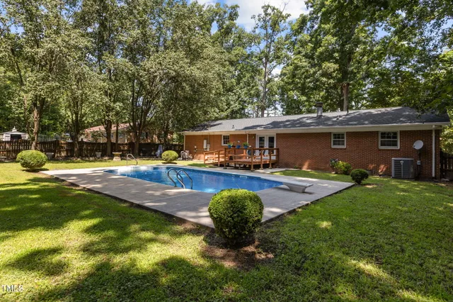 a view of a house with swimming pool and porch