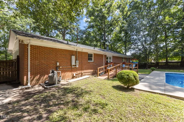a view of swimming pool with sitting area and slide