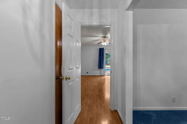 a view of a hallway with wooden floor