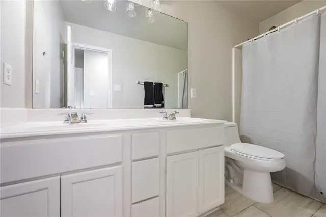a bathroom with a sink toilet and mirror