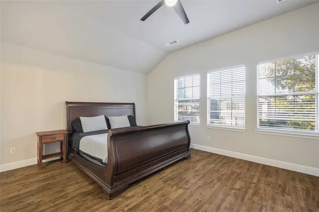 a living room with a bed furniture and a large window