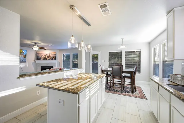a open kitchen with a table and chairs