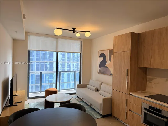 a view of a livingroom with furniture and a window