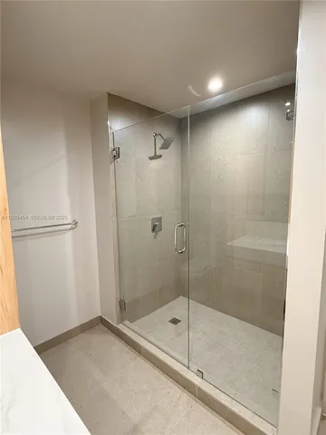 a bedroom with wooden floor and window