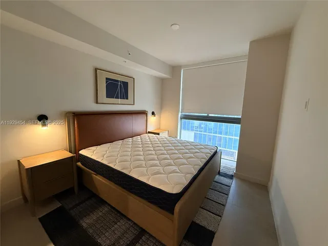 a bedroom with a bed and a mirror