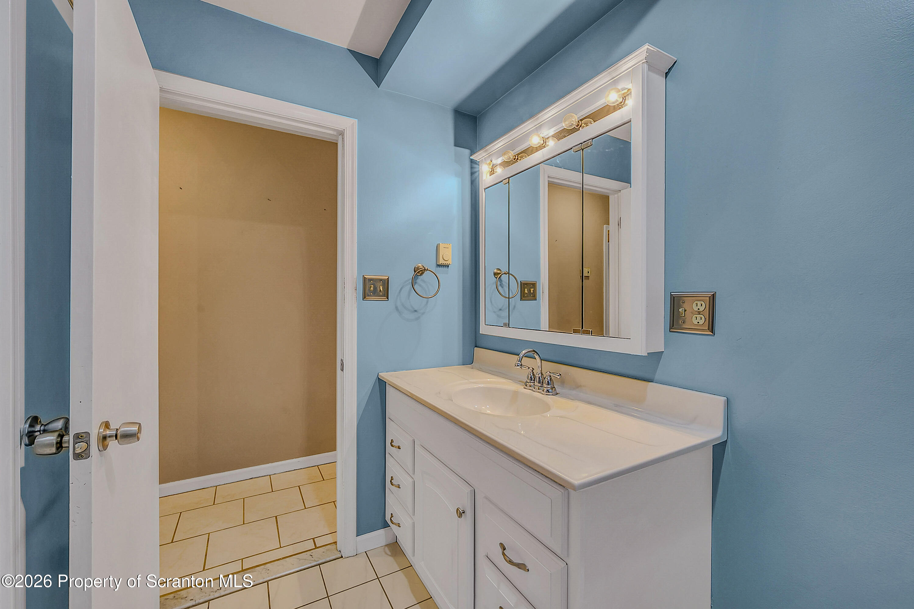102 Glenstone Road Dickson City, PA 18519 - Photo 11 of 39 a bathroom with a sink and a mirror