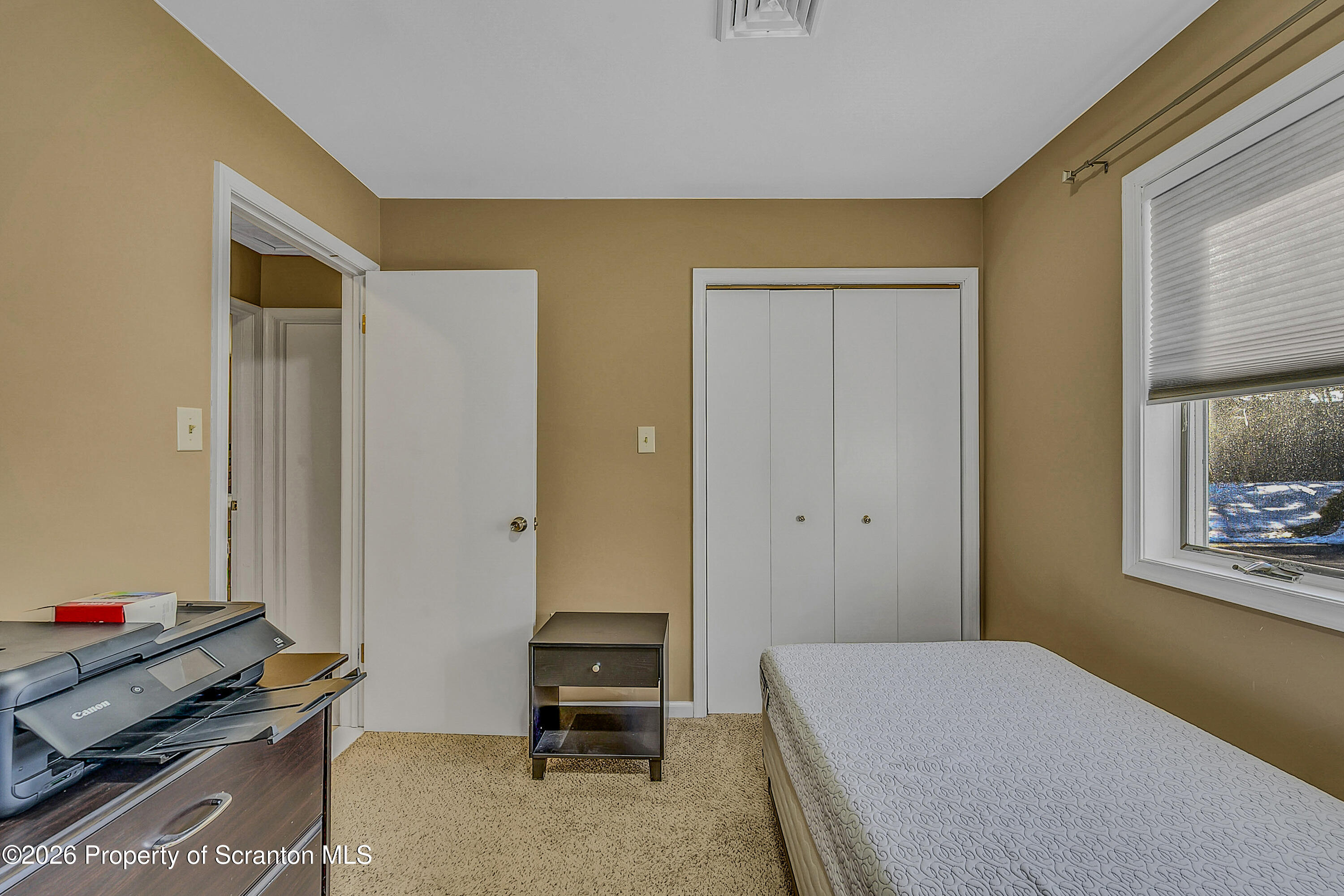 102 Glenstone Road Dickson City, PA 18519 - Photo 13 of 39 a bedroom with a bed and a table in it