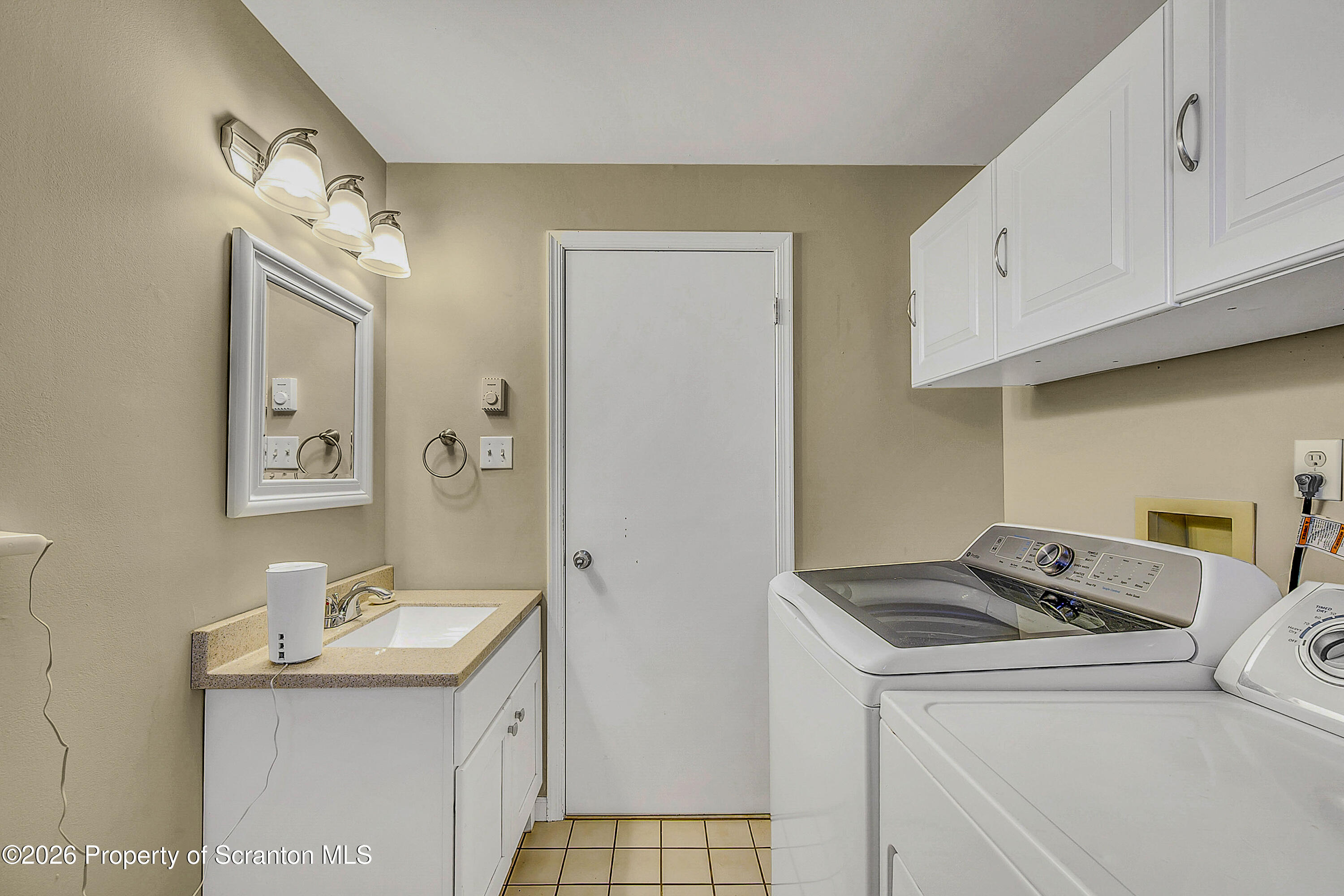 102 Glenstone Road Dickson City, PA 18519 - Photo 24 of 39 a utility room with cabinets washer and dryer