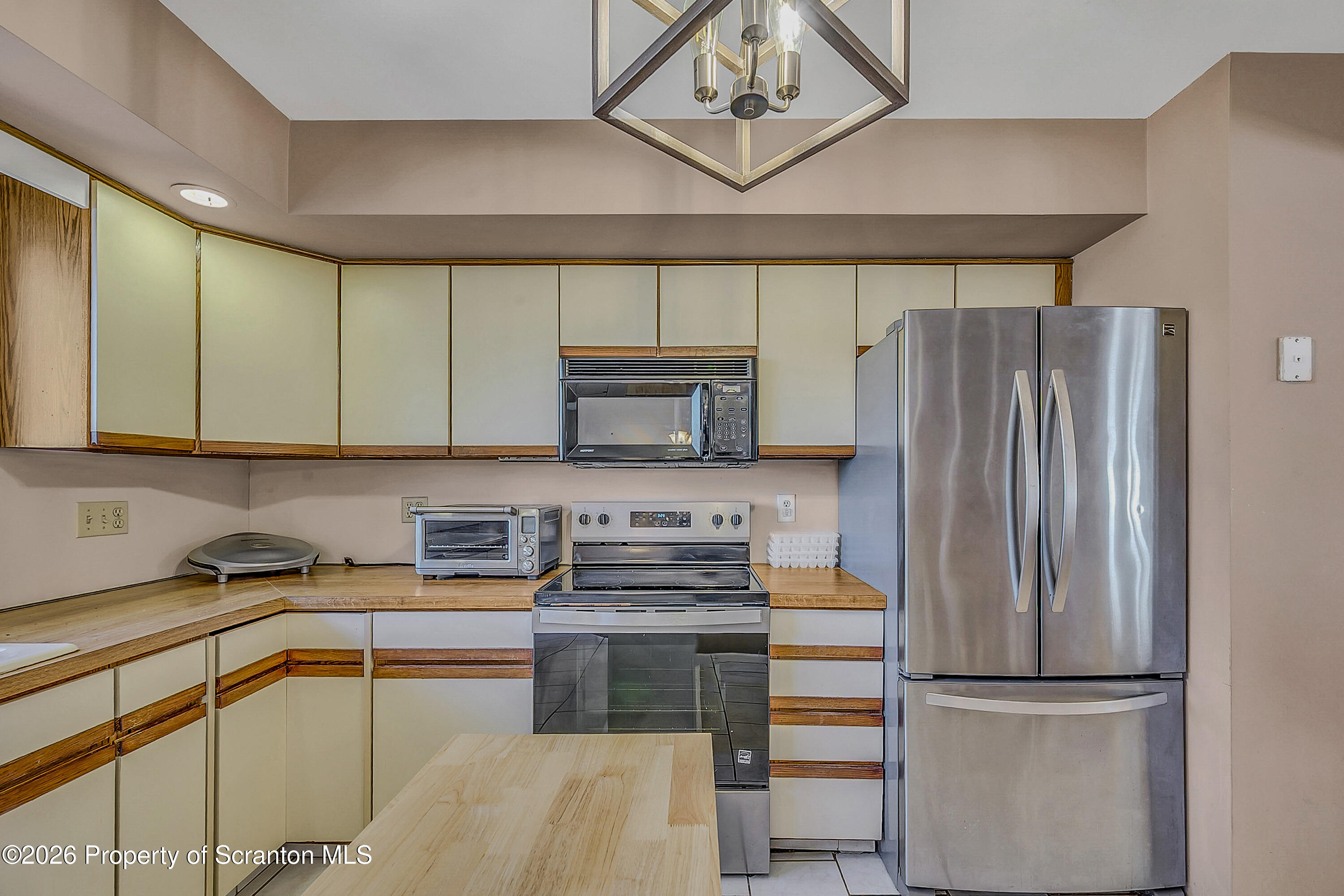 102 Glenstone Road Dickson City, PA 18519 - Photo 8 of 39 a kitchen with stainless steel appliances granite countertop a refrigerator and a sink