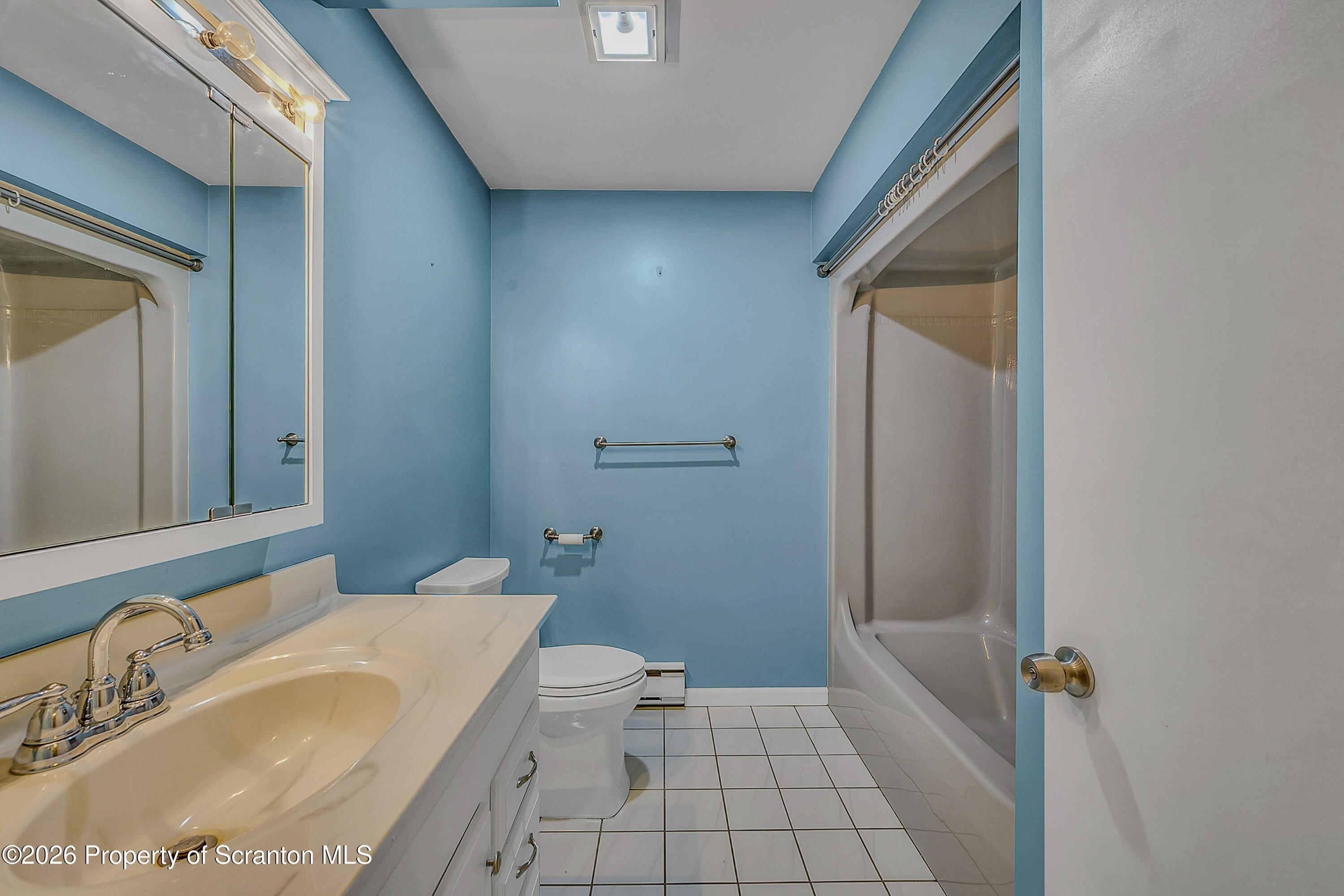 102 Glenstone Road Dickson City, PA 18519 - Photo 10 of 39 a bathroom with a sink and mirror with toilet