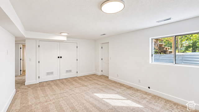342 East 600 North Logan, UT 84321 - Photo 14 of 19 Light-colored carpeting, white walls, and a window with a wood-framed exterior structure