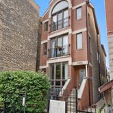 a front view of a residential apartment building with a yard