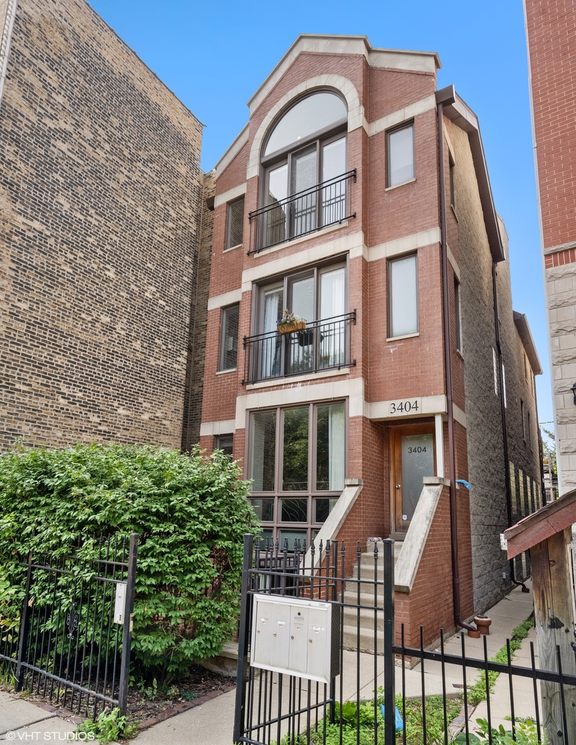 3404 North Seminary Avenue, Unit 1 Chicago, IL 60657 - Photo 1 of 15 a front view of a residential apartment building with a yard