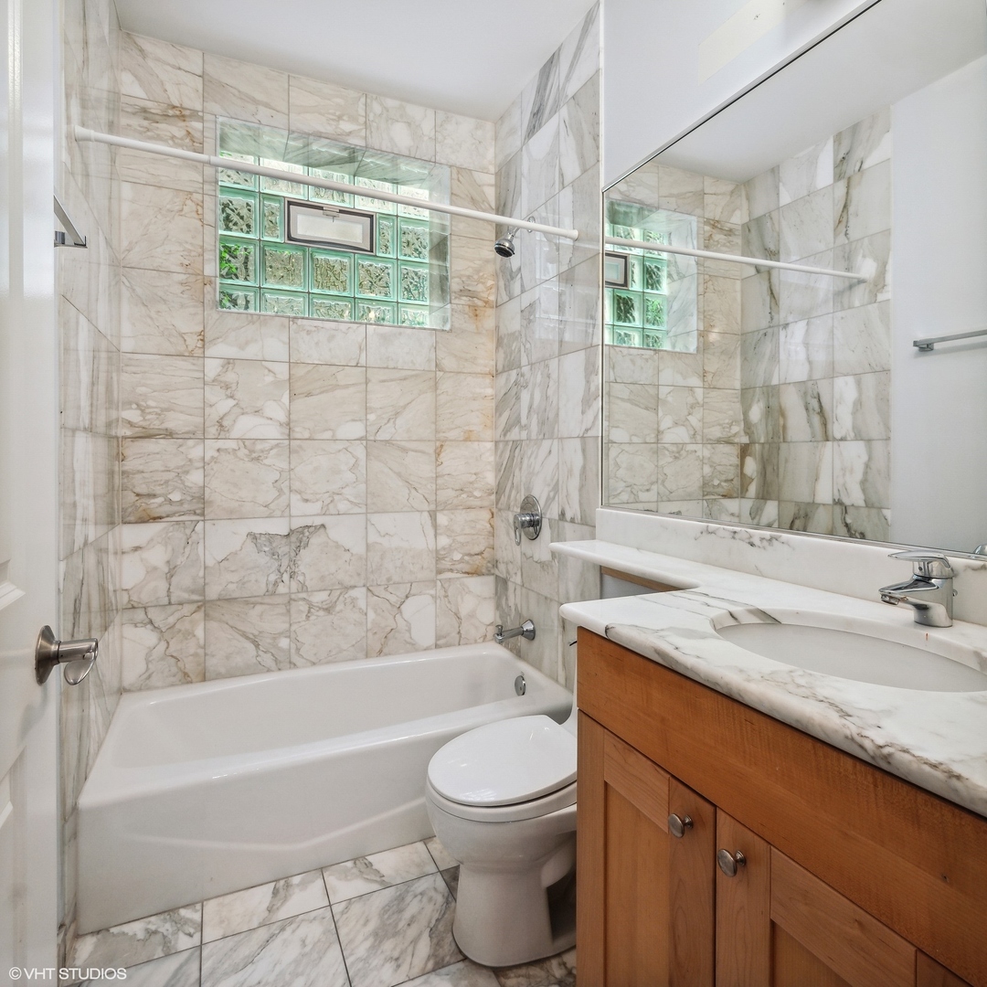 3404 North Seminary Avenue, Unit 1 Chicago, IL 60657 - Photo 13 of 15 a bathroom with a sink toilet and shower
